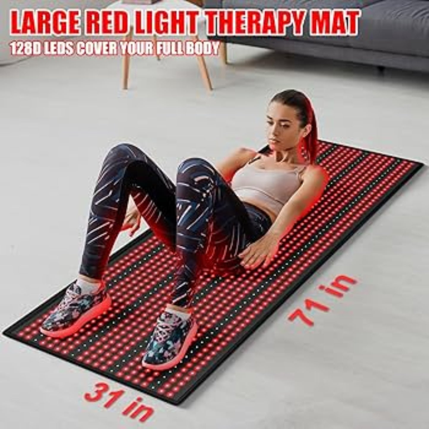 Person using a large red light therapy mat on a gray floor.